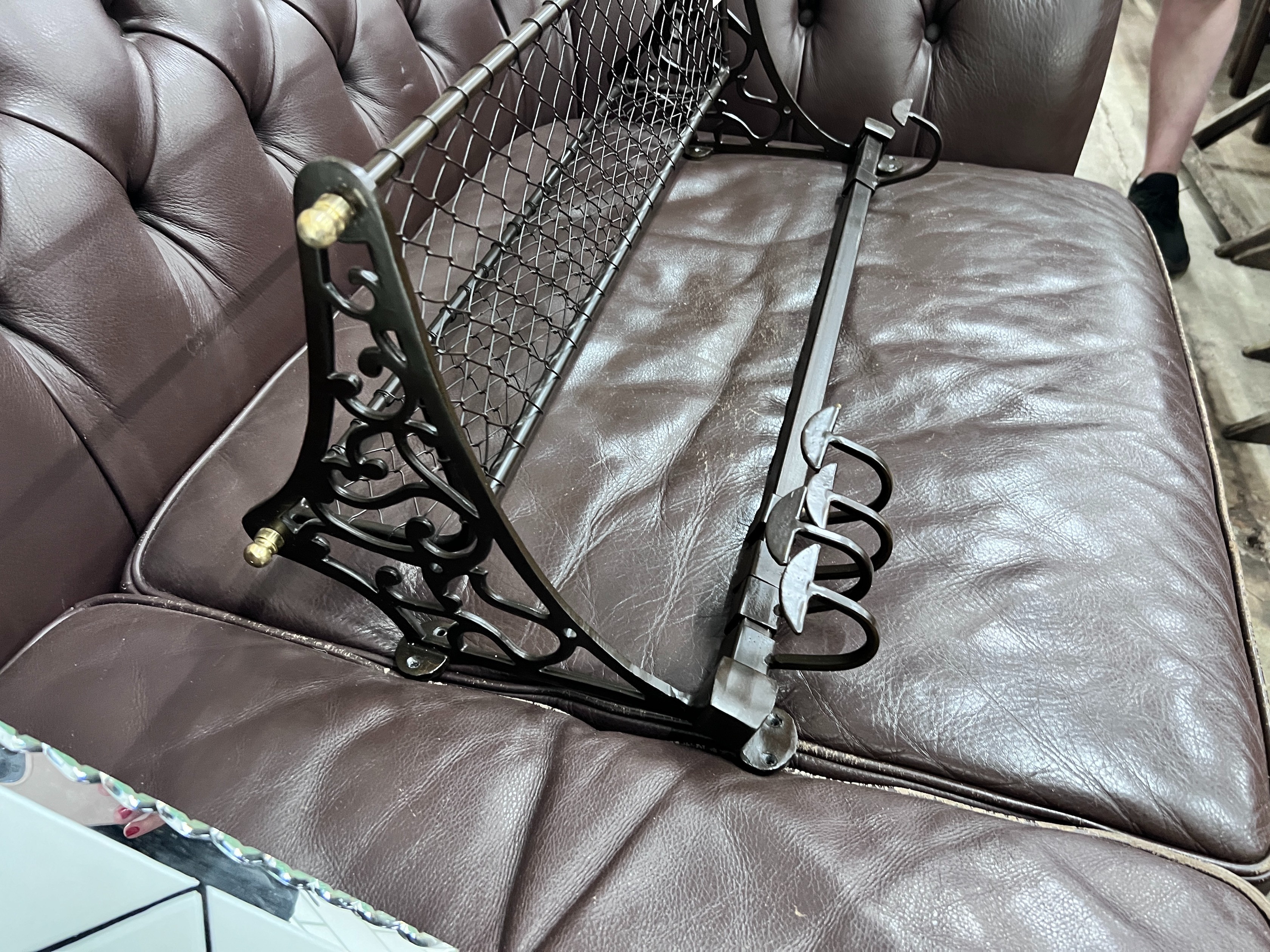A bronzed metal wall hanging coat rack, width 75cm *Please note the sale commences at 9am.